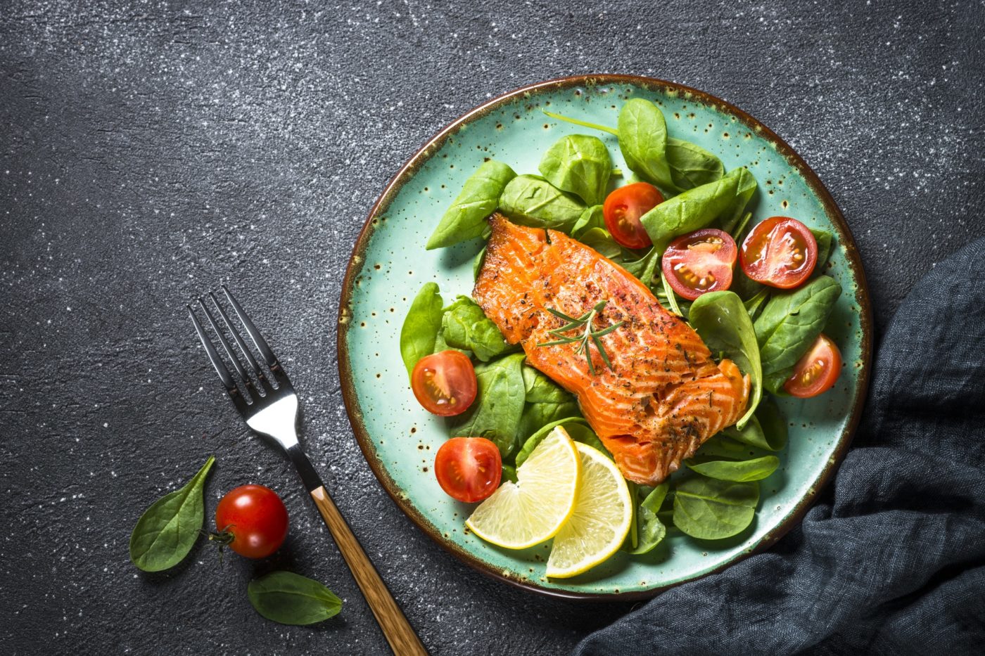 Baked salmon fish fillet with fresh salad top view