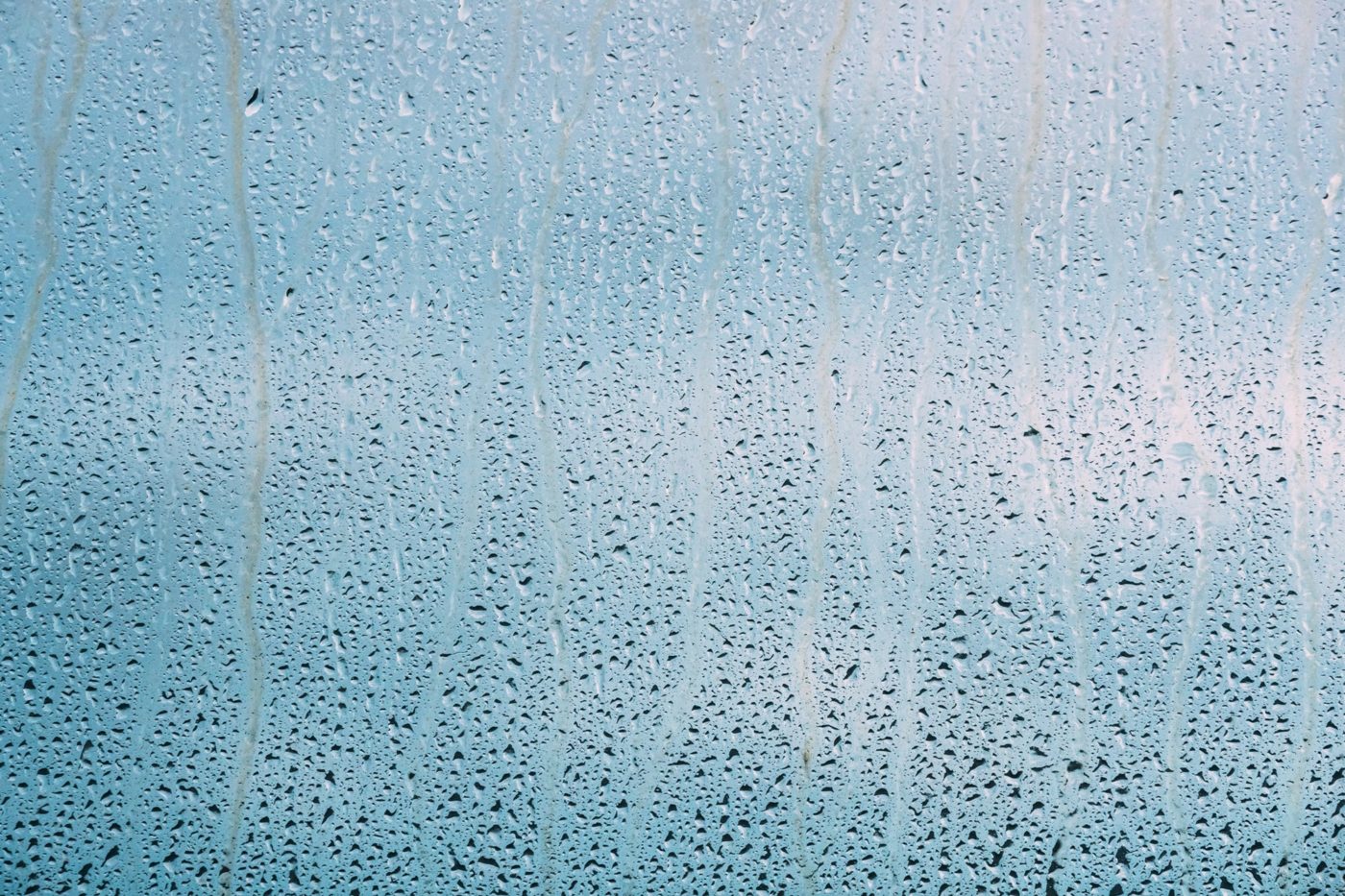 Drops Of Water Or Rain On Wet Glass Background. Moody Photo In C