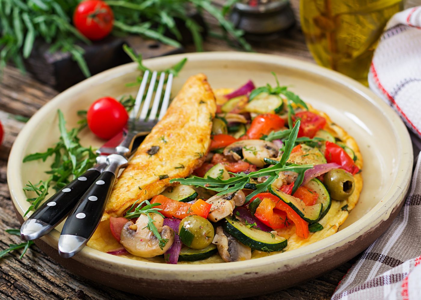 Omelet with tomatoes, zucchini and mushrooms. Omelette breakfast. Healthy food.