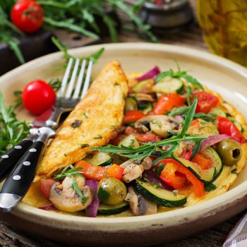 Omelet with tomatoes, zucchini and mushrooms. Omelette breakfast. Healthy food.