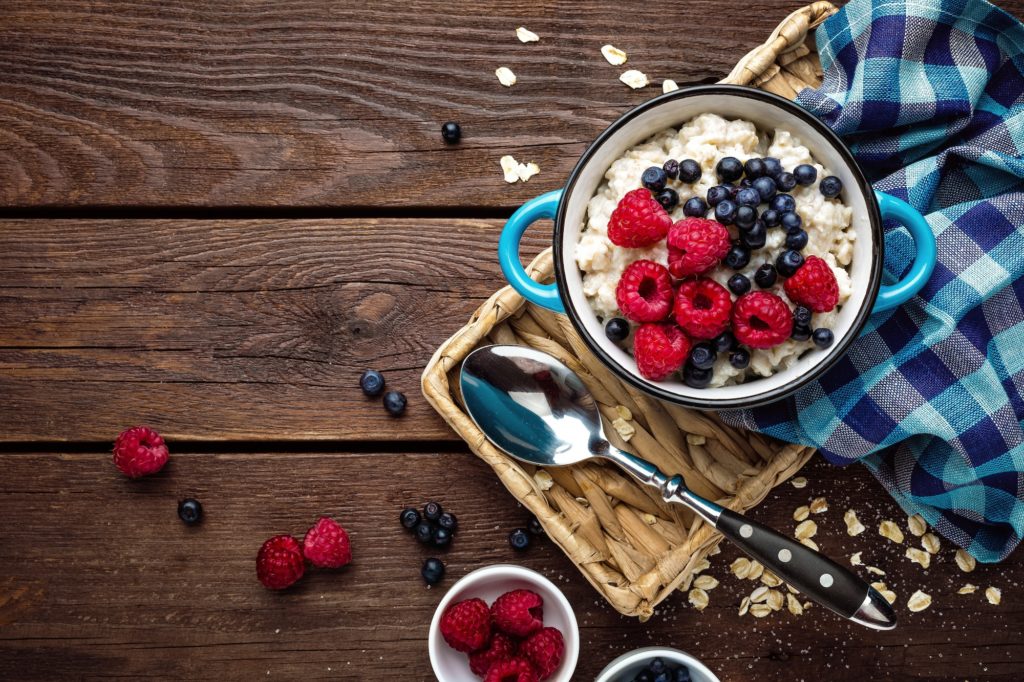 Oatmeal porridge with fresh berries, oats with blueberry and raspberry